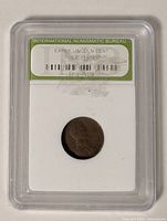 Front view of INB slab containing coin