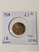 Reverse side of 1934 Canadian one cent coin in flip showing denomination and date