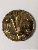 Reverse showing torch and V design with 1943 date