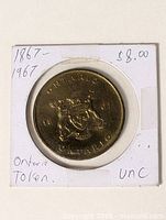 Front view showing Ontario coat of arms and dates 18-67