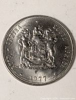 Obverse of 1977 South Africa 1 Rand coin showing coat of arms and year