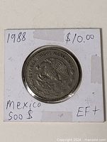 Coin in 2x2 flip showing both sides and handwritten notes