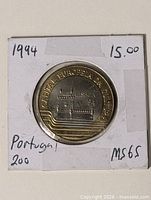 Coin in 2x2 flip showing obverse side and handwritten MS65 note