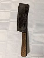 Full view of cleaver showing iron blade and wood handle