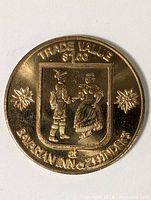 Obverse of brass trade token showing full design and inscriptions
