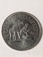 Obverse of coin showing CALGARY STAMPEDE DOLLAR and cowboy scene