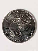 Reverse showing Hamilton Canada Anniversary Dollar design with industrial scene, soldier and text