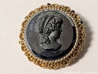 Front view of hematite cameo brooch