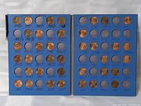 Folder open displaying two panels filled with Lincoln cents