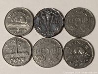 Group of six Canadian nickels showing obverse designs and dates