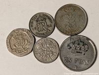 Group of five coins showing obverses