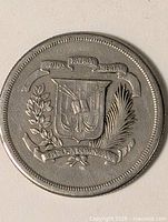 Full view of coin side with coat of arms and motto