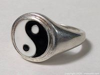 Angled front view showing Yin Yang face and band