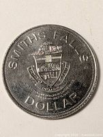 Obverse showing Smiths Falls coat of arms and dollar denomination