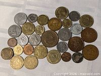 All coins laid out on white cloth showing obverse designs and relative sizes