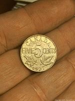 Reverse side showing CANADA FIVE CENTS 1927 and maple leaves