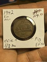 Obverse side showing pig design and holder annotations