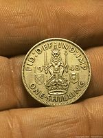 Reverse of 1948 one shilling coin with crowned lion and shields