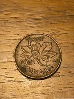 Reverse side of 1951 Canada 1-cent coin with maple leaves and date