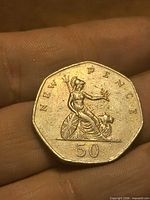 Reverse of 50p coin: seated Britannia with lion, denomination 50 NEW PENCE visible