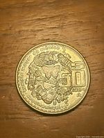 Reverse of 1984 50 pesos coin showing Coyolxauhqui design and denomination