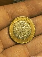 Reverse showing Aztec Sun Stone design and denomination.