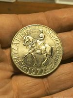 Obverse of coin displaying Queen on horseback and legend