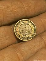 Reverse of 1908 Indian Head cent displaying shield and ONE CENT inscription