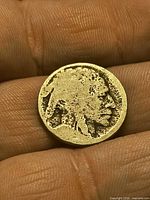 Obverse of worn Indian Head Buffalo nickel in hand