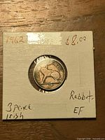 Coin reverse showing Irish hare and denomination 3d, holder notation 1962 Rabbit EF