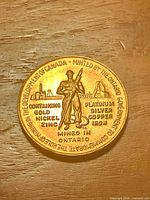 Full view of obverse showing miner, inscriptions and gold plating