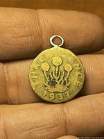 Obverse showing worn thistle design, date 1937, attached bail