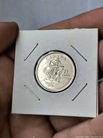 Reverse view of coin in 2×2 holder showing sailing ship design and 1604-2004 legend