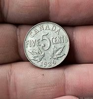 Reverse of 1926 Canada 5 cent coin in hand