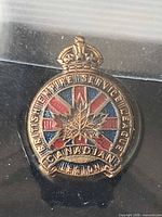Front view of enamel Canadian Legion pin showing design and text