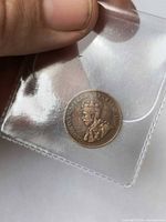 Obverse showing King George V in clear sleeve