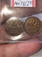 Reverse of both coins showing dates 1931 and 1947 in plastic flip