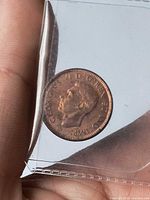 Obverse of 1944 Canada 1 cent showing King George VI portrait in holder