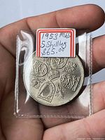 Reverse of 1953 5 shilling coin showing quartered shields