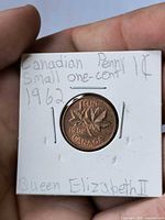 Reverse of 1962 Canada 1 cent coin in flip showing maple leaves design and date