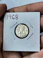 Reverse view of coin in 2x2 flip with handwritten year