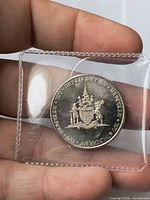 Thunder Bay coat of arms side of 1970 trade dollar in plastic flip