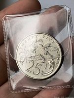 Reverse of 25 cent coin with hummingbird and denomination