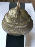 Top view showing hanging loop and carved decoration