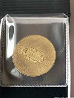 Obverse showing Canada coat of arms and CANADA inscription inside holder