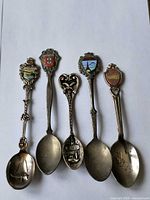 Full view of five collector spoons front side