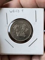 Reverse of 2000 Canada 25-cent Millennium quarter in 2x2 flip showing fireworks and flag design