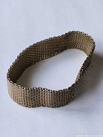 Entire bracelet laid flat showing mesh construction