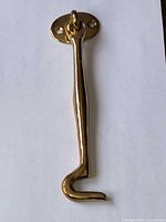 Front view of solid brass latch hook on white background