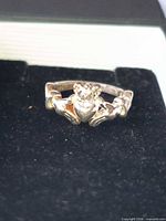 Front view of sterling silver Claddagh ring in box showing crowned heart and hands motif